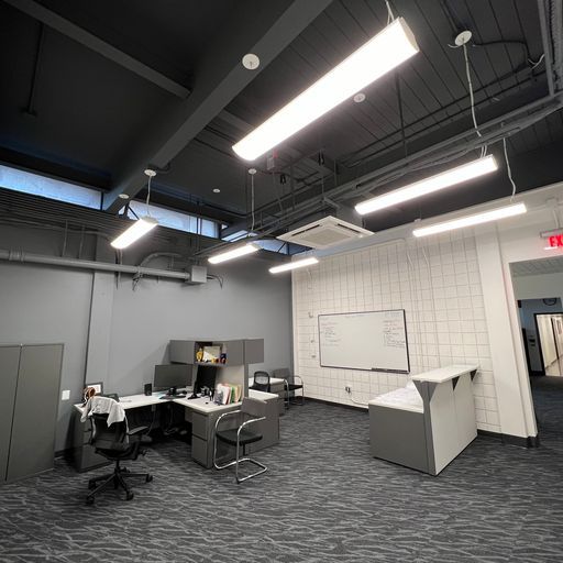 A large room with a lot of lights hanging from the ceiling.