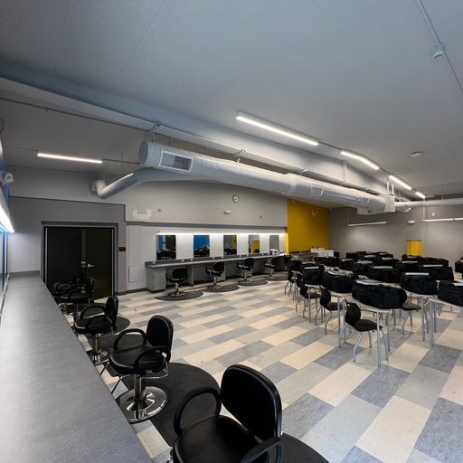 A large room with tables and chairs in it