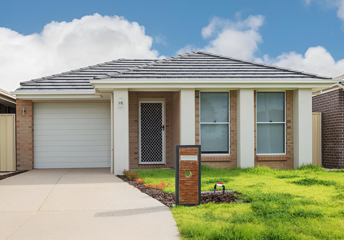A House With a White Garage Door and a Mailbox in Front of It — MJ Render in Buderim, QLD