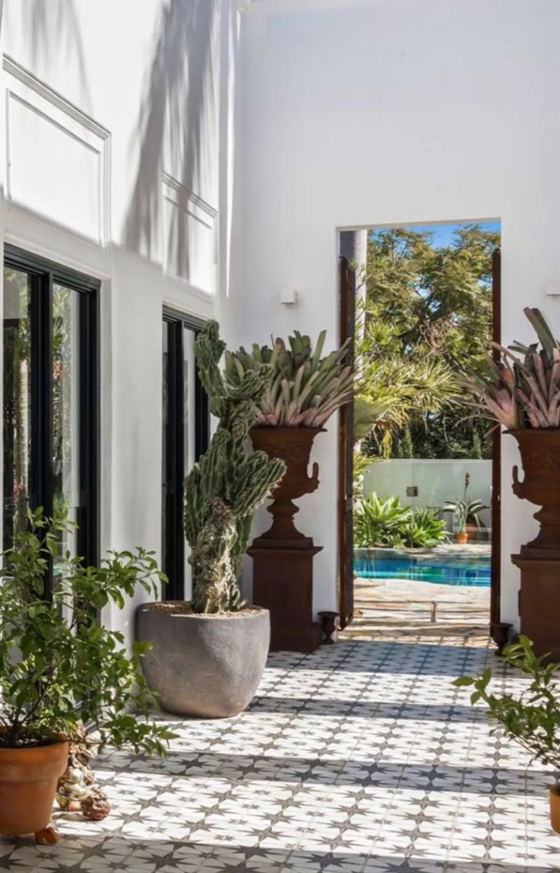 A Courtyard with Potted Plants and A Swimming Pool in The Background — MJ Render in Buderim, QLD