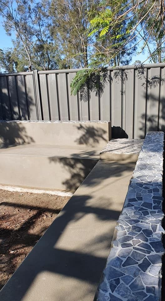A Concrete Bench Is Sitting Next to A Fence in A Backyard — MJ Render in Buderim, QLD