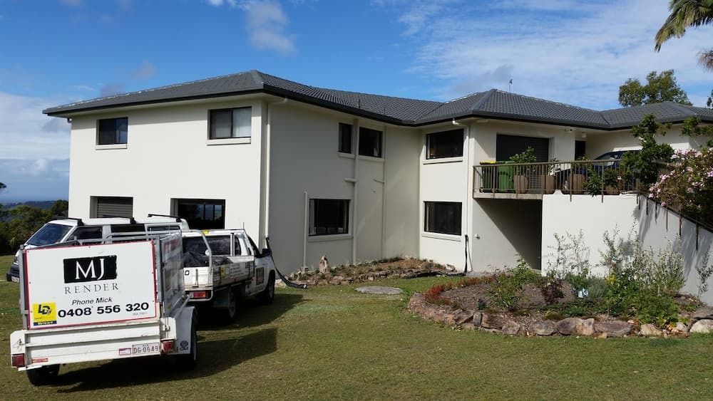 A Large White House with A Truck Parked in Front of It — MJ Render in Buderim, QLD