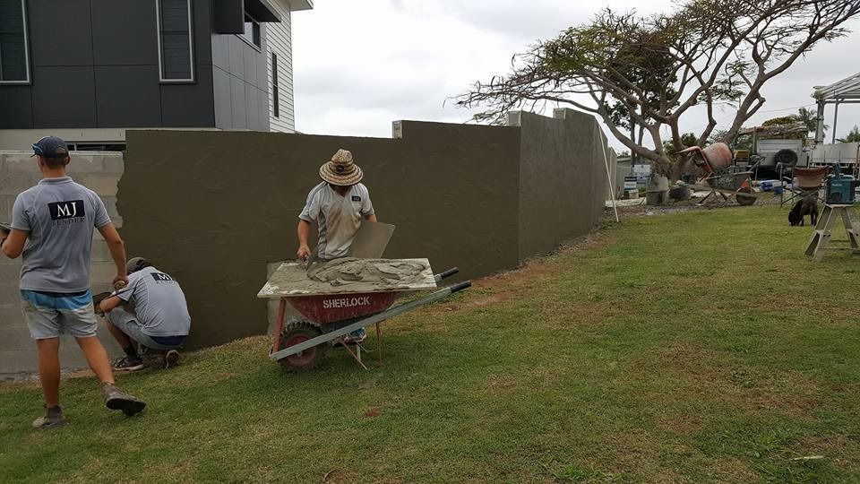 A Group of Men Are Working on A Fence in A Yard — MJ Render in Buderim, QLD