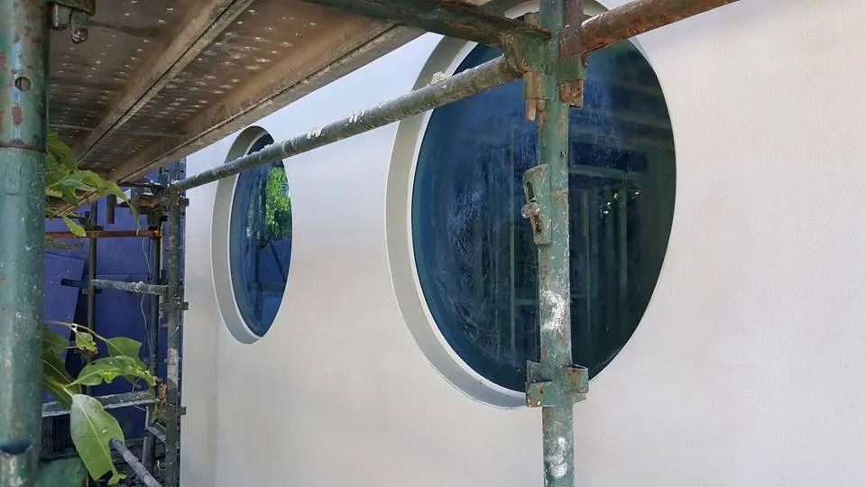 A White Wall with Three Round Windows on It — MJ Render in Buderim, QLD