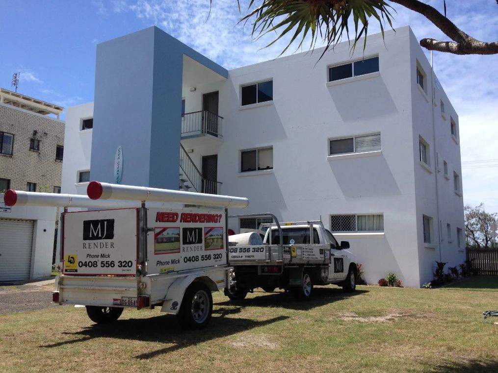 Two Trucks Are Parked in Front of A Large White Building — MJ Render in Buderim, QLD