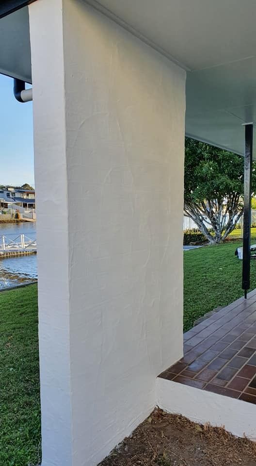 A White Wall Next to A Brick Walkway with A View of A Body of Water  — MJ Render in Buderim, QLD
