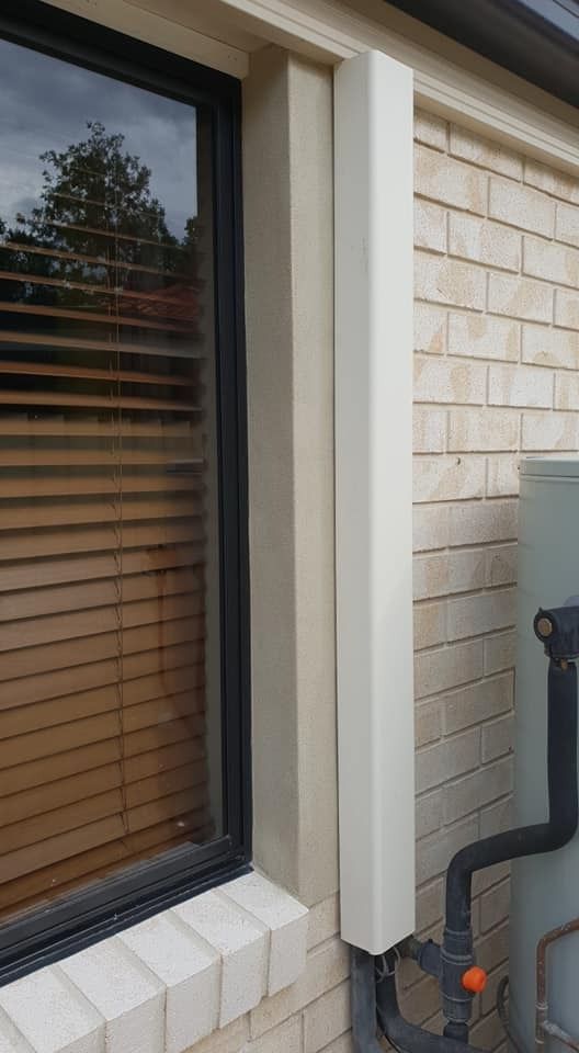 A Brick Building with A Window and A Water Tank on The Side — MJ Render in Buderim, QLD