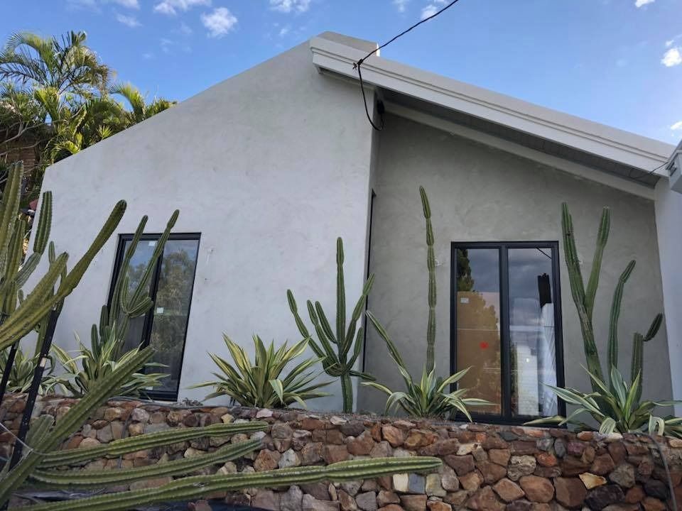 A White House with A Stone Wall and Cactus in Front of It — MJ Render in Buderim, QLD