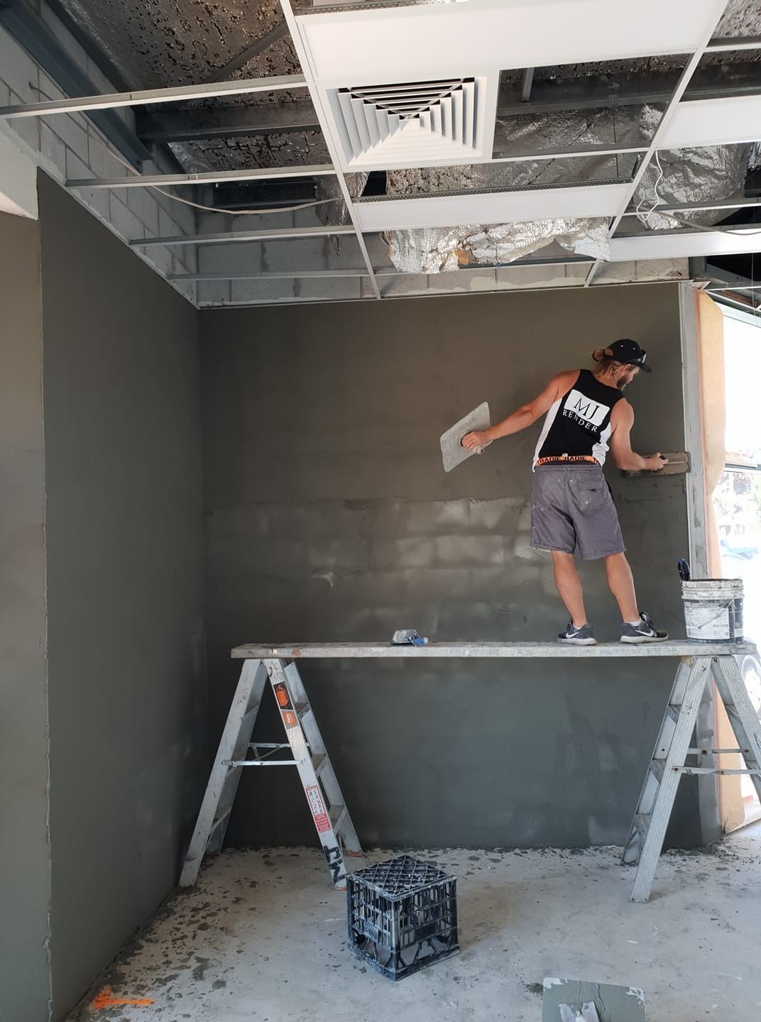 A Man Is Standing on A Ladder and Plastering a Wall — MJ Render in Buderim, QLD