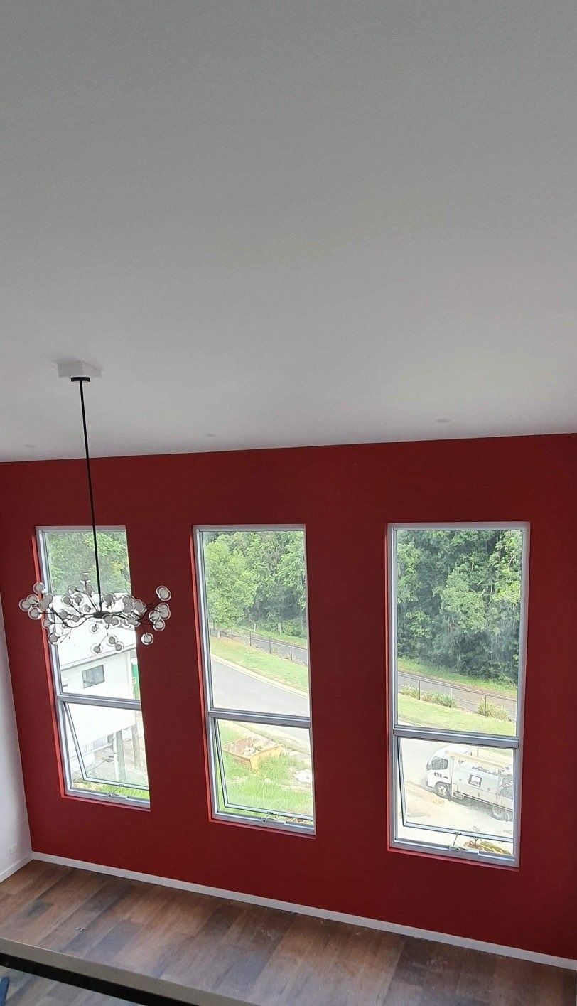 A Room with Red Walls and Three Windows with A Chandelier Hanging from The Ceiling — MJ Render in Buderim, QLD