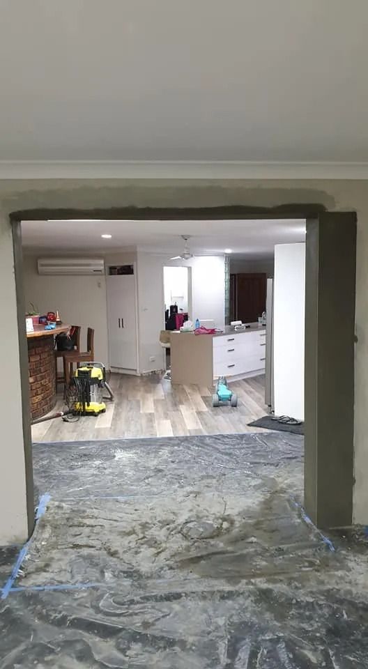 A Living Room with A Sliding Glass Door Leading to A Kitchen — MJ Render in Buderim, QLD