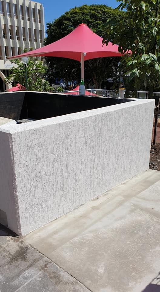 A Pink Umbrella Is Sitting on Top of A White Wall — MJ Render in Buderim, QLD