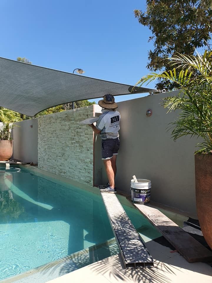 A Man Is Painting a Wall Next to A Swimming Pool — MJ Render in Buderim, QLD