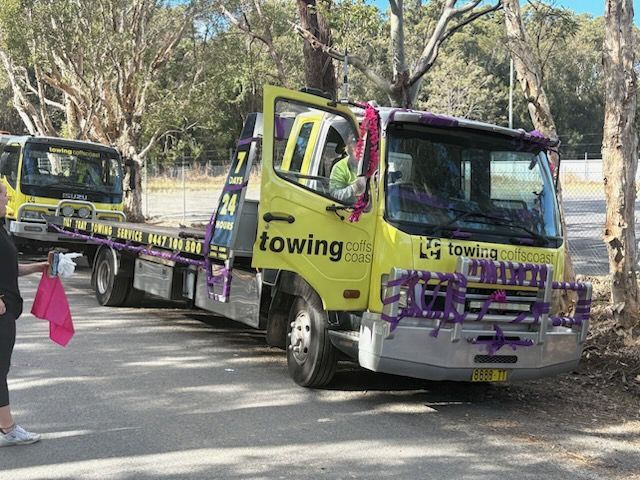 A TCC Tow Truck is towing a Ute while parked on gravel road — TCC Towing Coffs Coast in Harbour, NSW