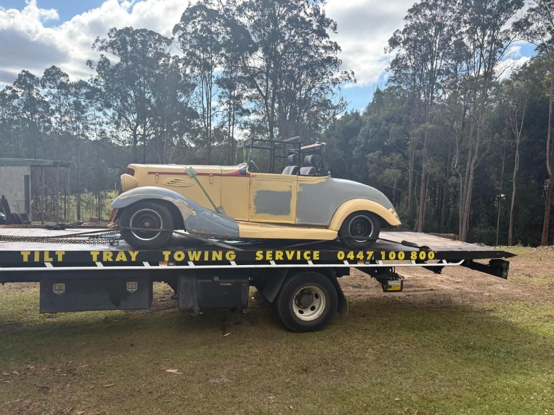 A Classic Car Is Being Towed by A Trailer — TCC Towing Coffs Coast in Harbour, NSW