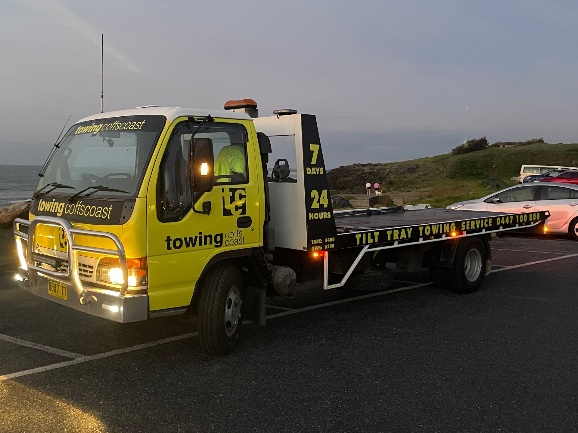 A Motorbike Is Being Towed by A Tow Truck — TCC Towing Coffs Coast in Harbour, NSW