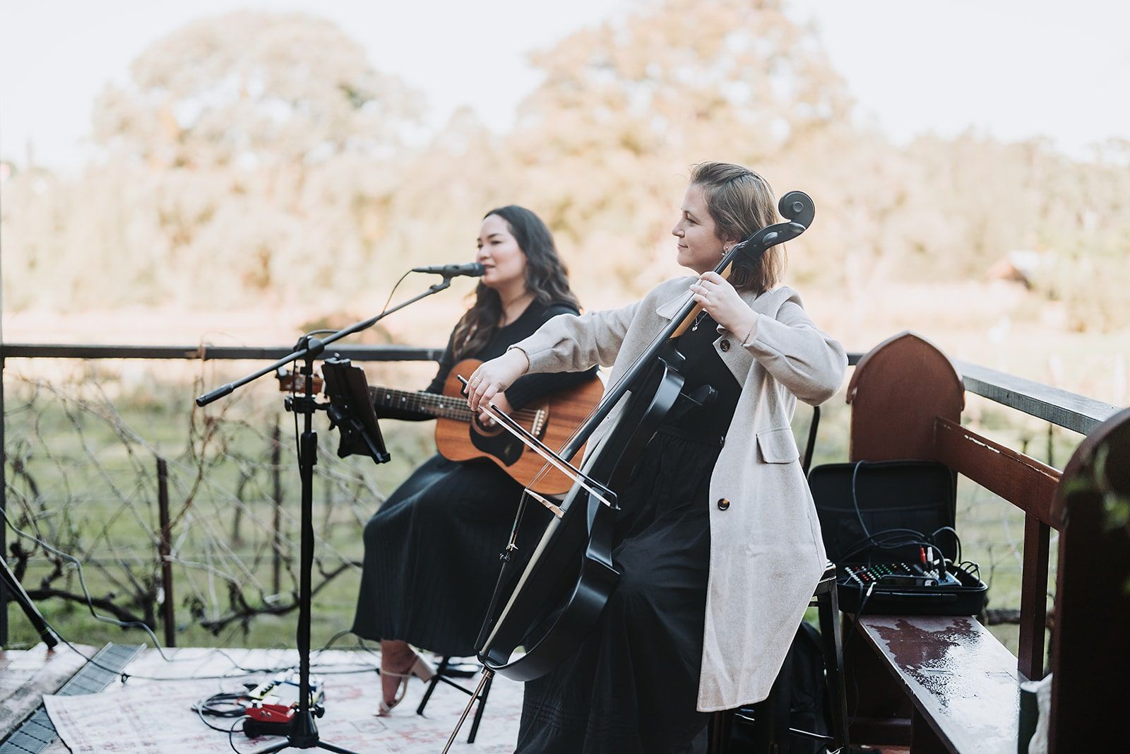 Band performing on stage in front of a brick wall: saxophone, vocals, bass, drums, and keyboard.