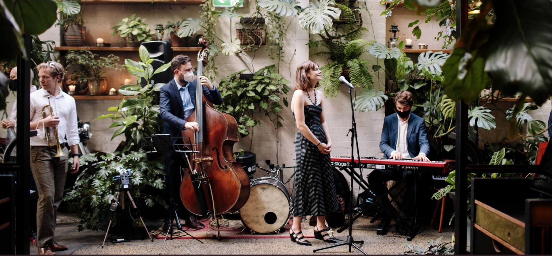A group of people are playing instruments in a room.