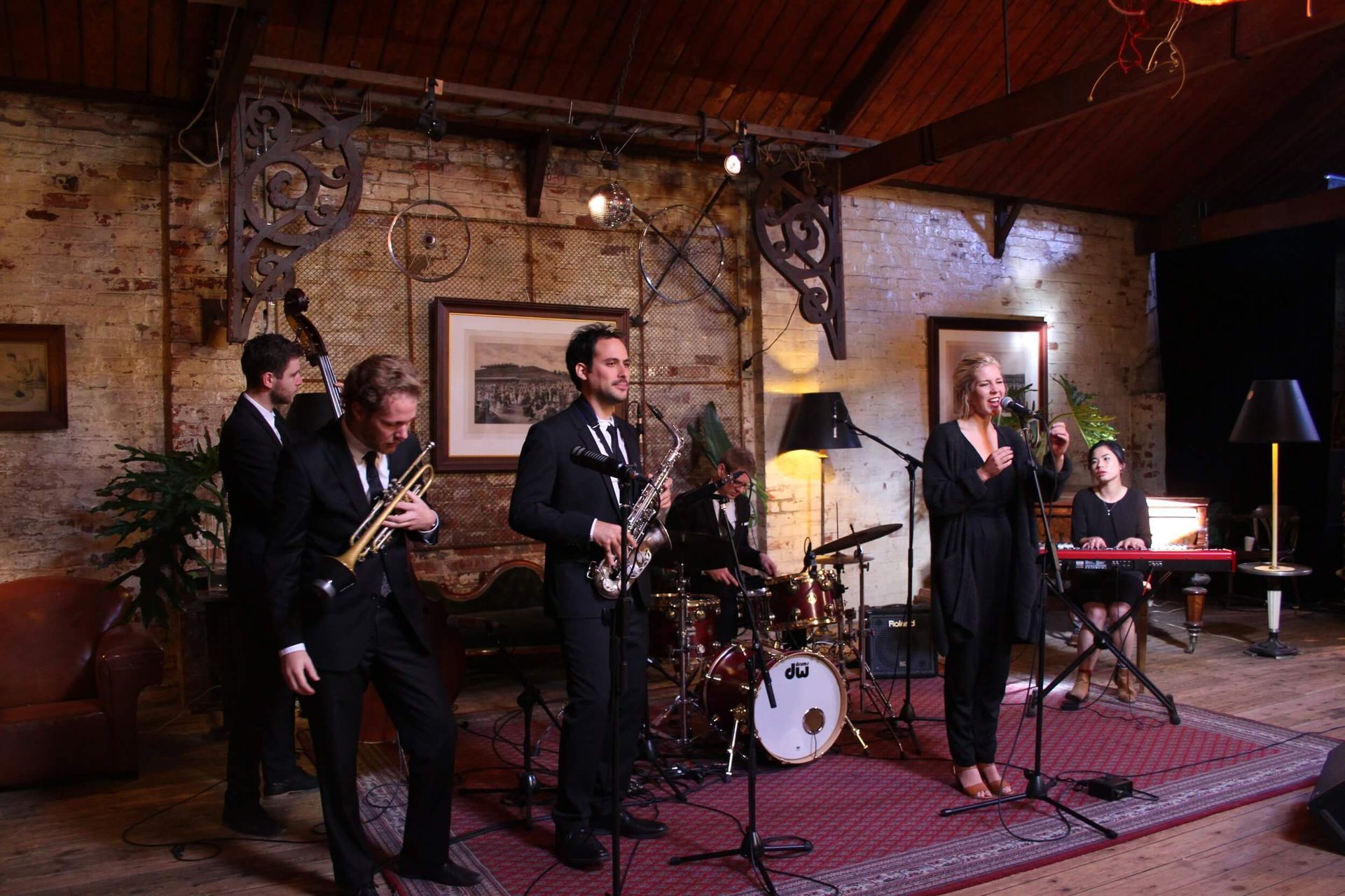 A group of people are playing instruments in a room.