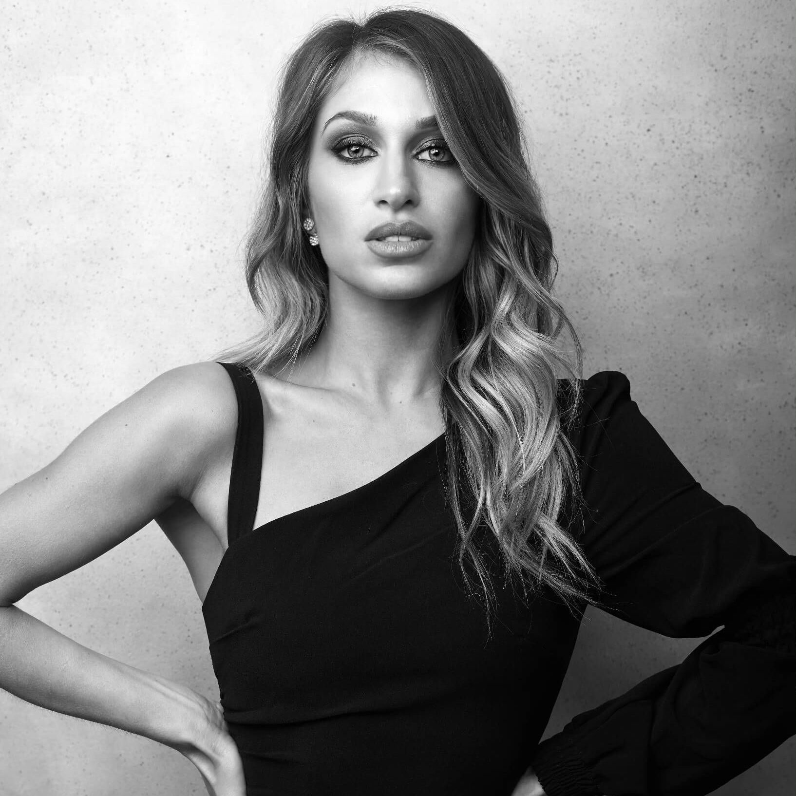 A black and white photo of a woman in a black dress