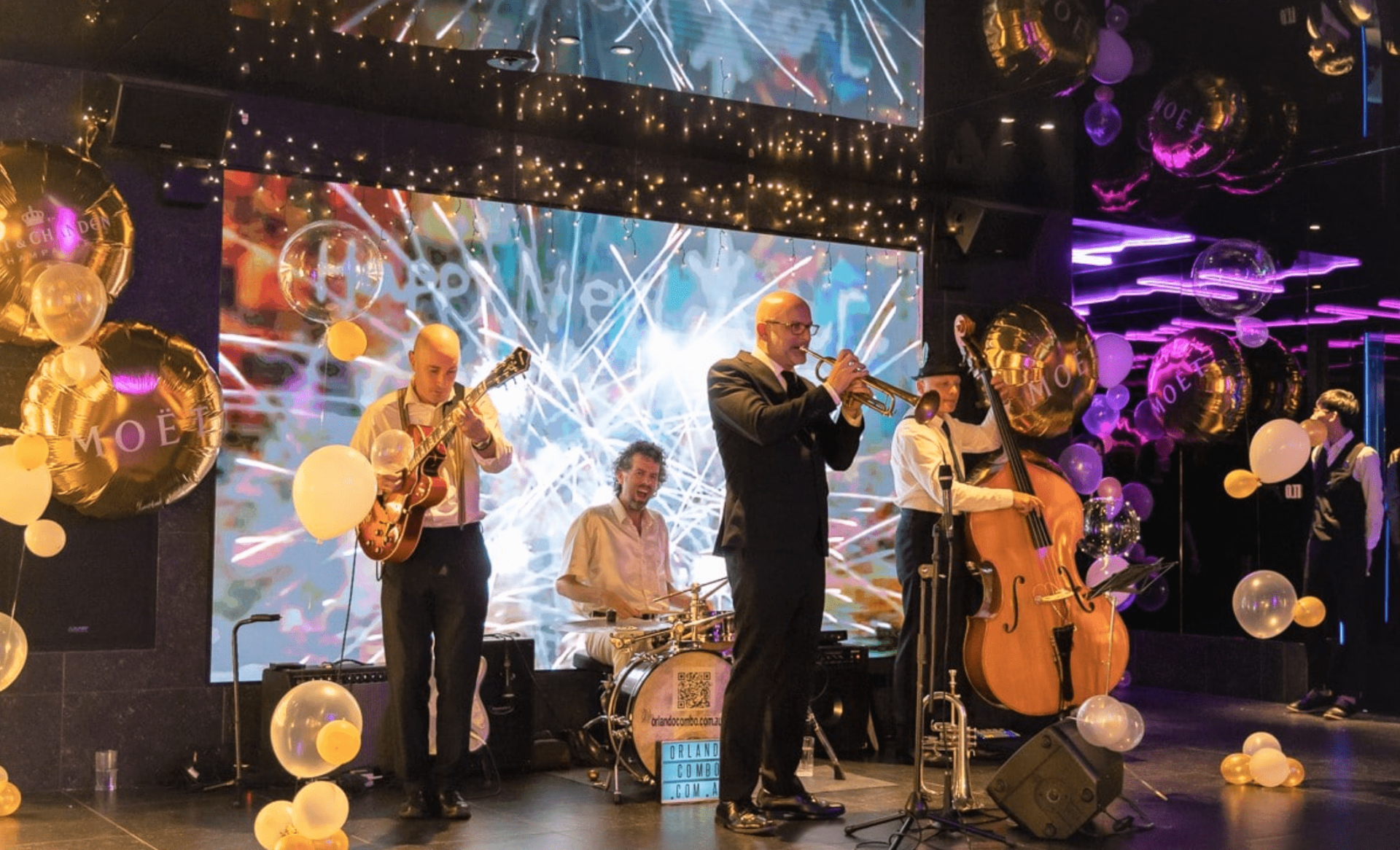 A group of men are playing instruments on a stage.