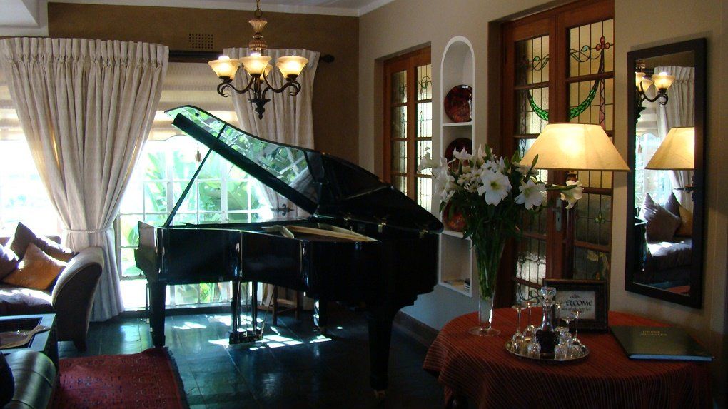 A living room with a piano and a mirror