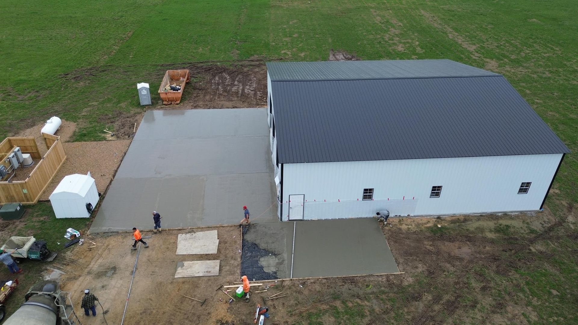 An aerial view of a building under construction in a field.