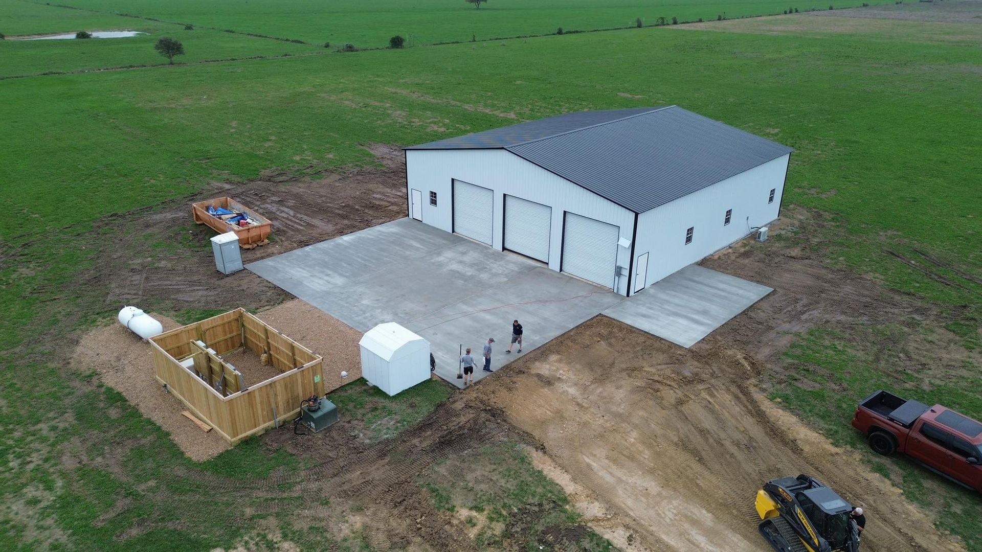 An aerial view of a building under construction in a field.