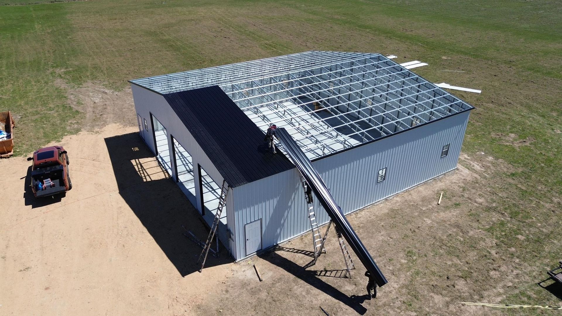 An aerial view of a building with solar panels on the roof.