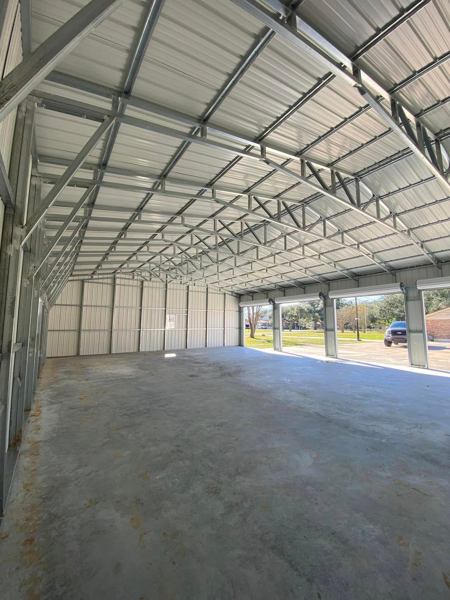 A large empty building with a lot of metal beams and a roof.
