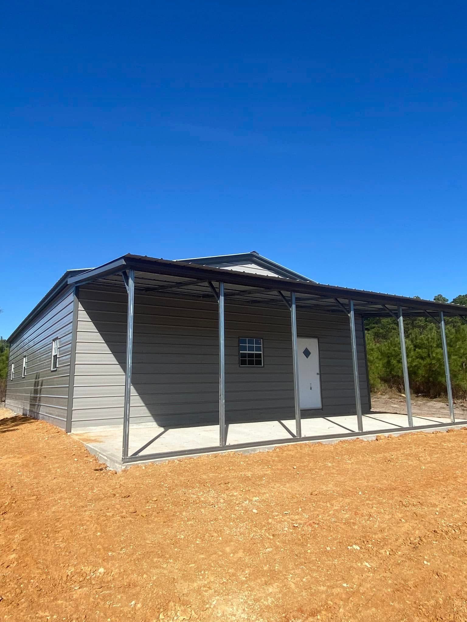 A small house with a porch and a blue sky in the background.