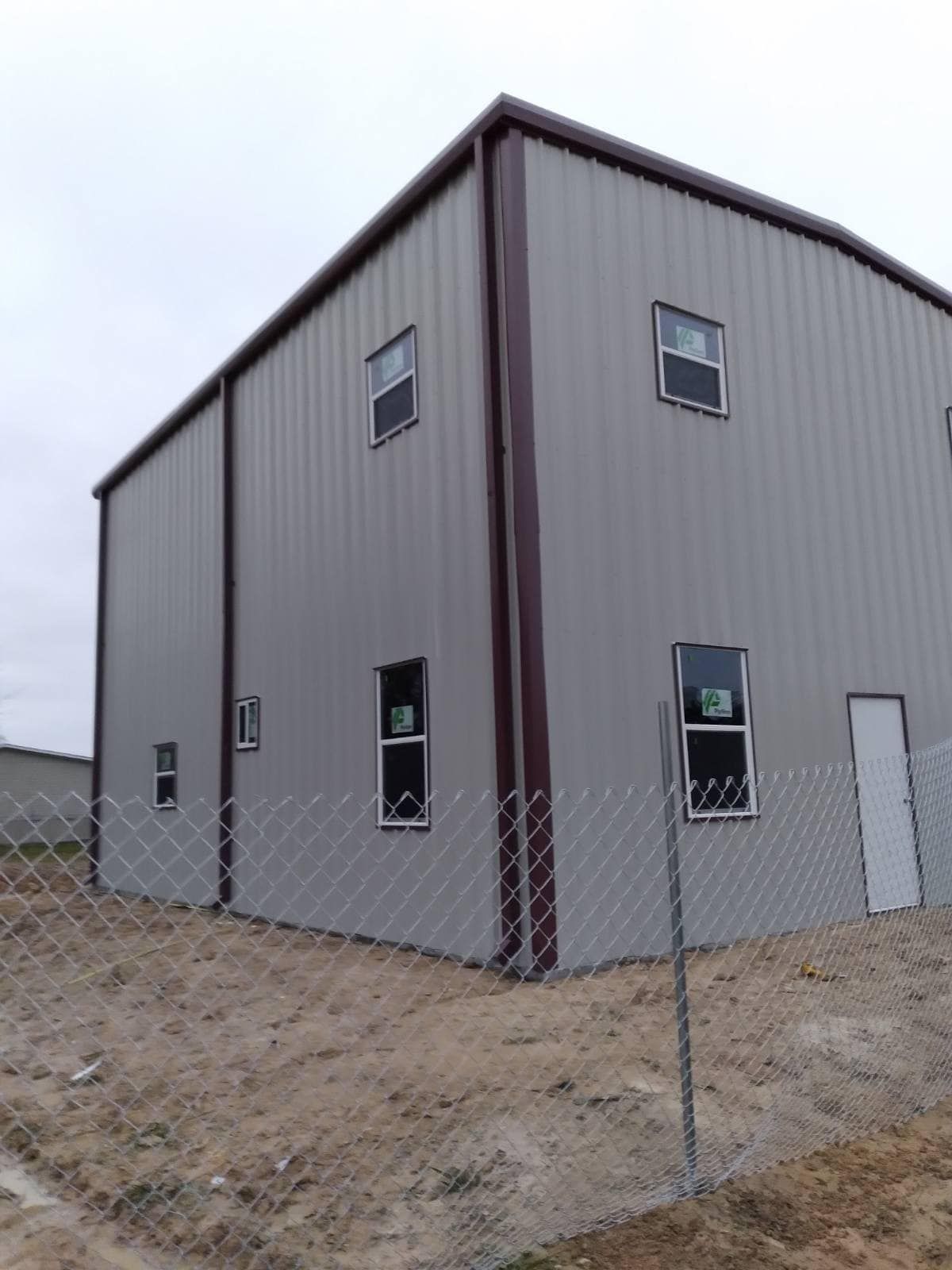 A large building with a chain link fence around it