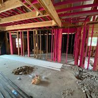 A house is being built with pink walls and a pink ceiling.