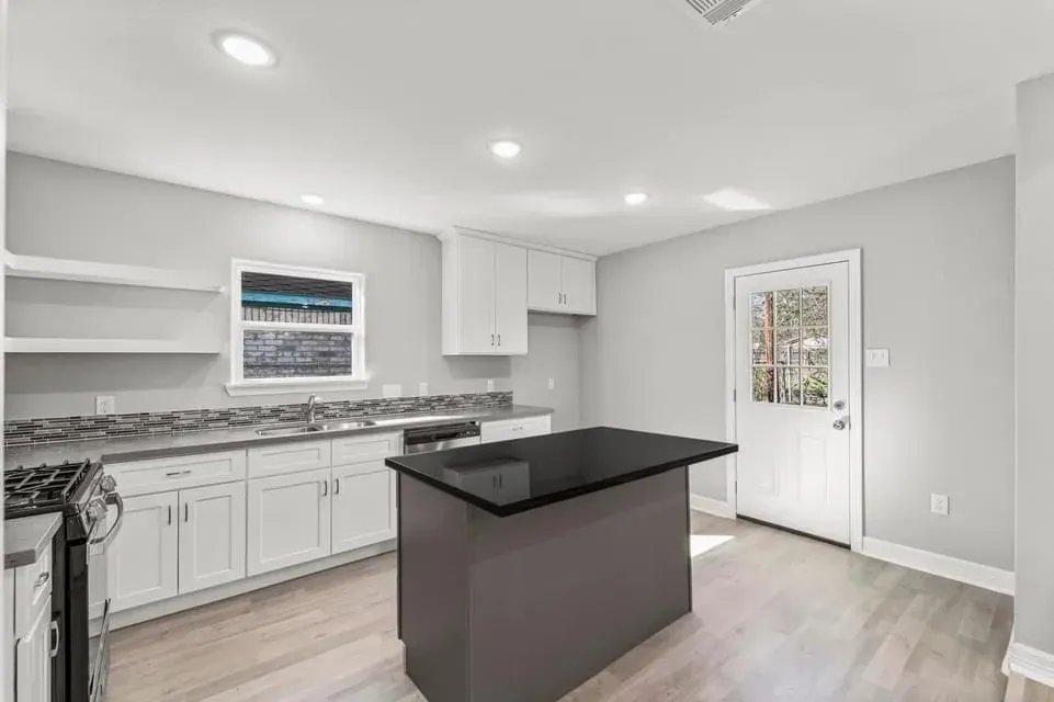 A kitchen with a large island in the middle of the room.