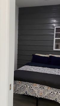 A bedroom with a bed and a window.