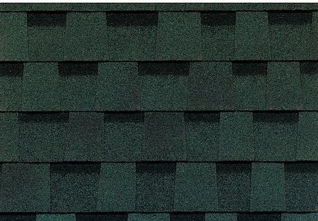 A close up of a row of green shingles on a roof.
