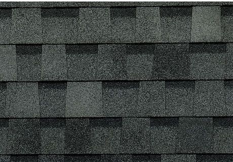 A close up of a roof with a lot of shingles on it.