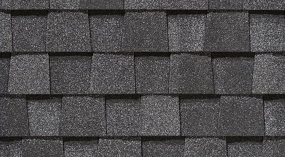 A close up of a black shingle roof.