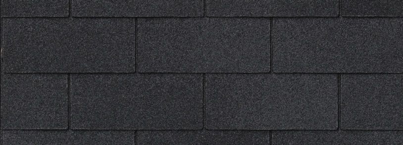 A close up of a black roof tile.
