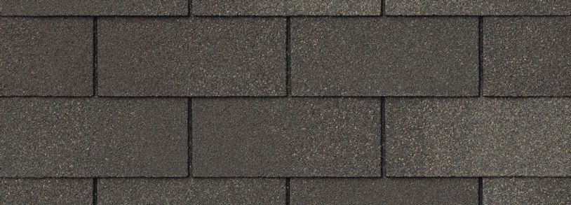 A close up of a row of gray shingles on a roof.