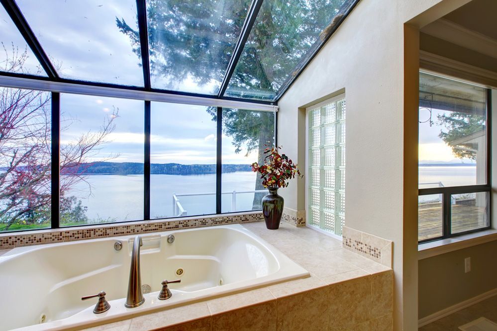 A Bathroom With A Jacuzzi Tub And A View Of The Ocean — Ace Glass & Aluminium In Grafton, NSW