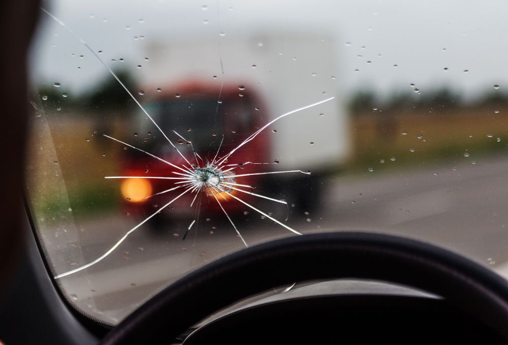 A Broken Windshield Of A Car With A Truck In The Background — Ace Glass & Aluminium In Grafton, NSW