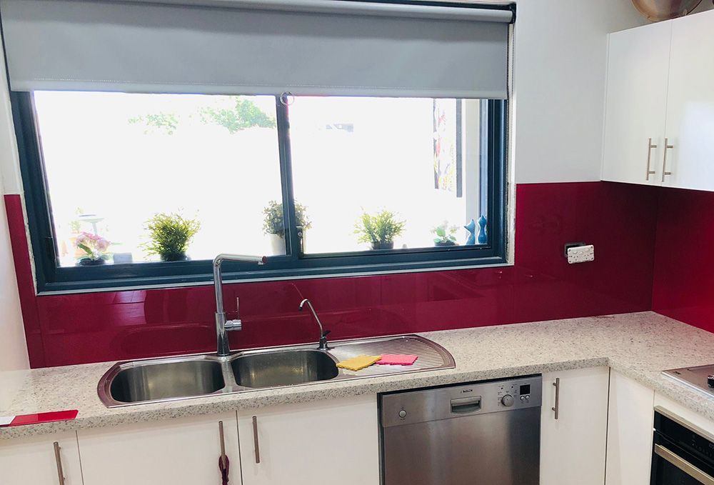 Kitchen With White Cabinets, Red Backsplash, And An Aluminum Window Window — Ace Glass & Aluminium In Grafton, NSW
