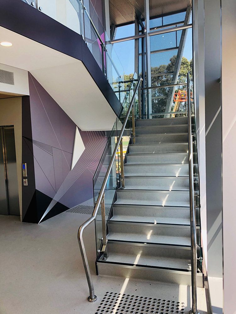 A Staircase In A Building With A Stainless Steel Railing — Ace Glass & Aluminium In Grafton, NSW