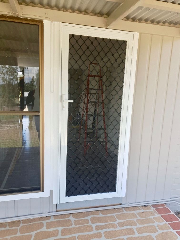 A White Door With A Ladder In The Background — Ace Glass & Aluminium In Grafton, NSW