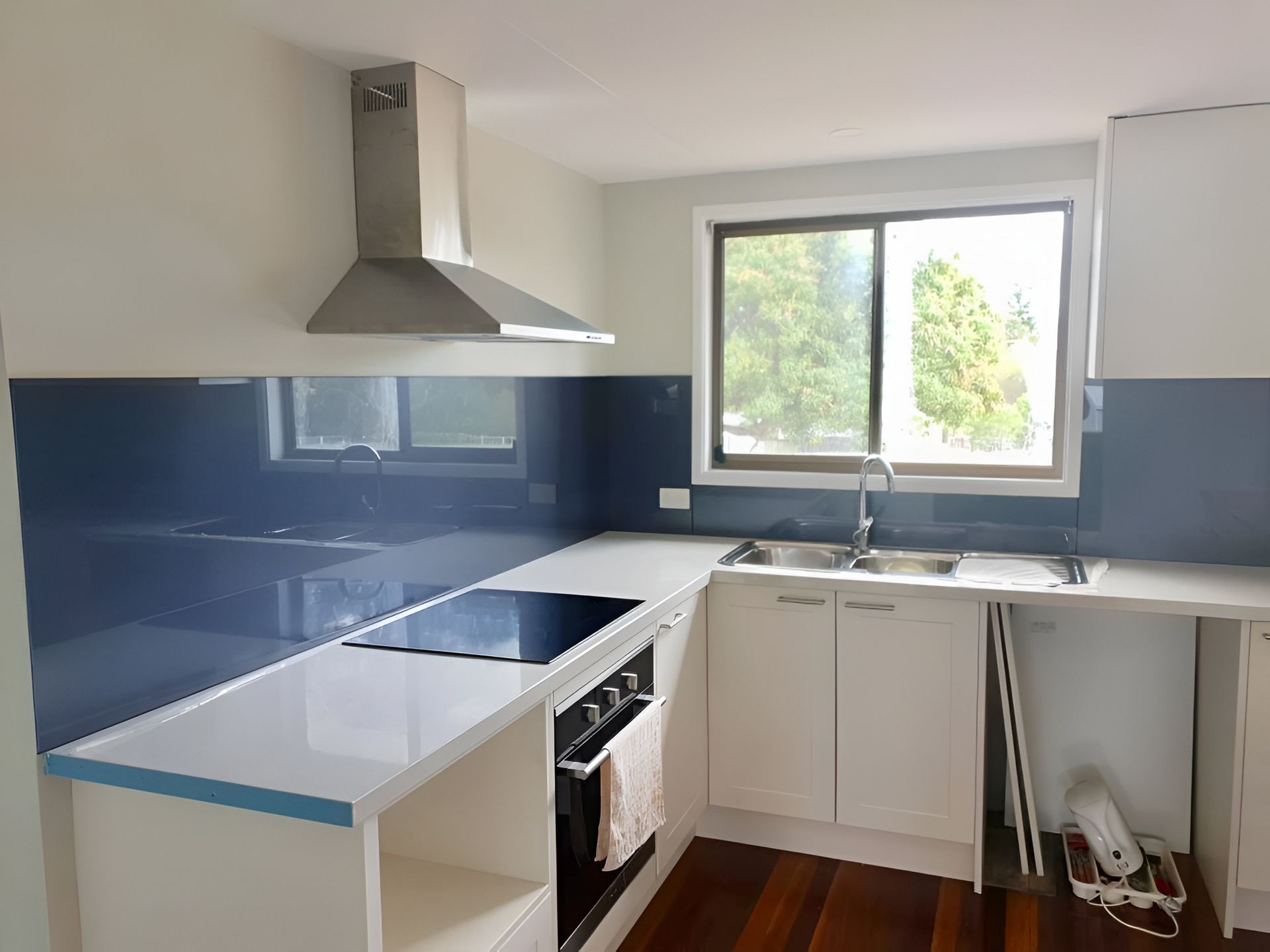 Modern Kitchen With White Countertops Near Aluminium Windows
