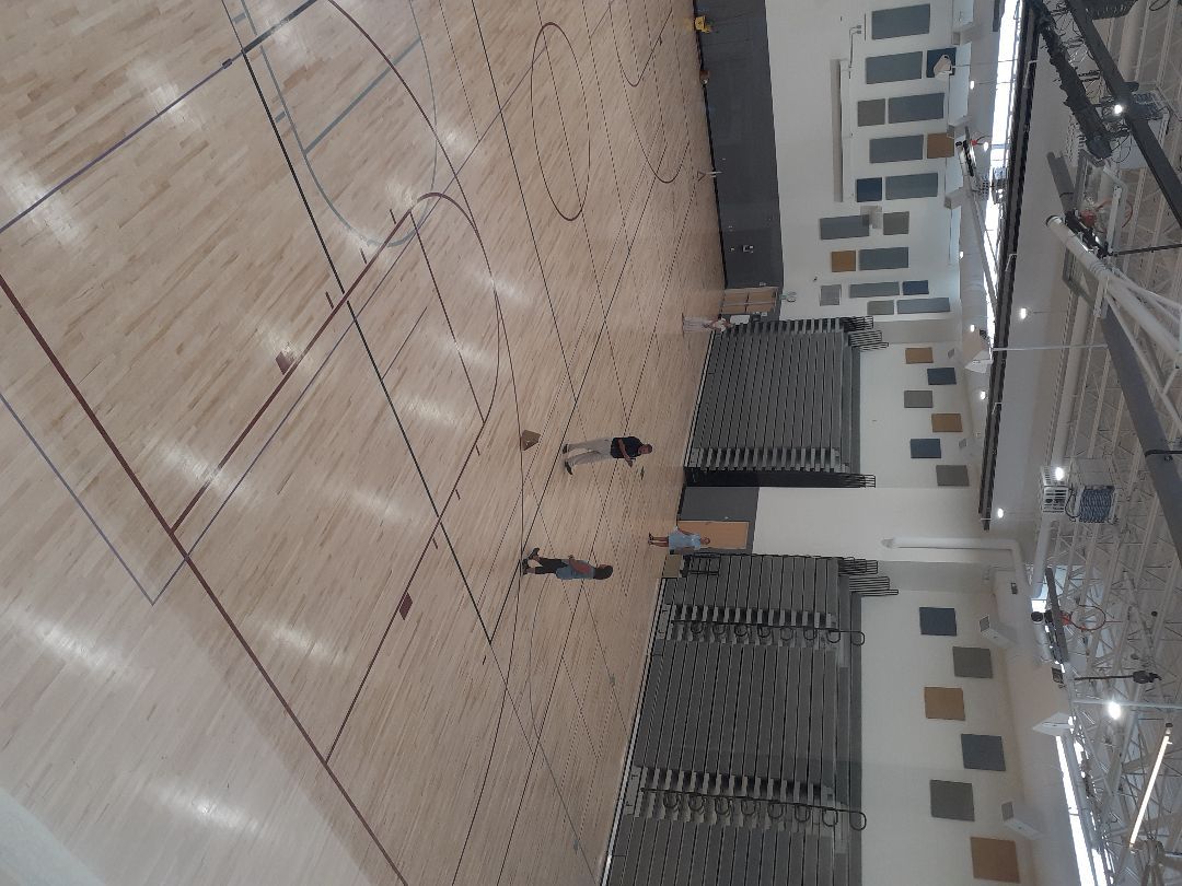 An aerial view of a gym with a wooden floor