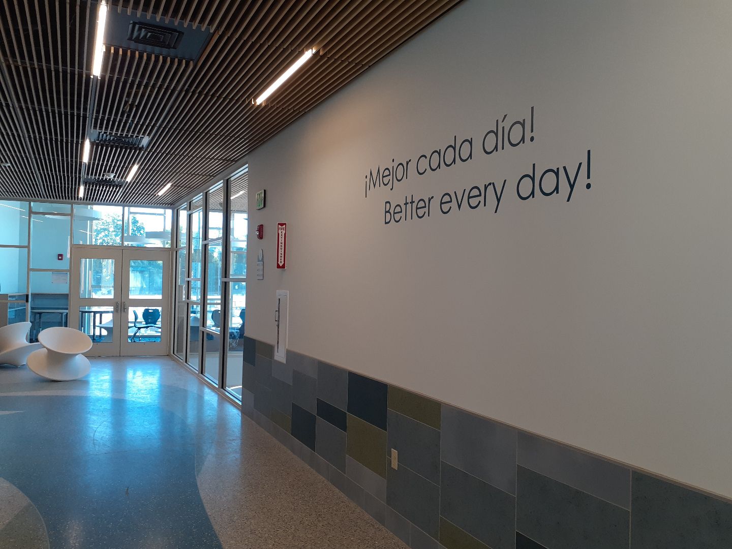 A hallway with a sign on the wall that says 