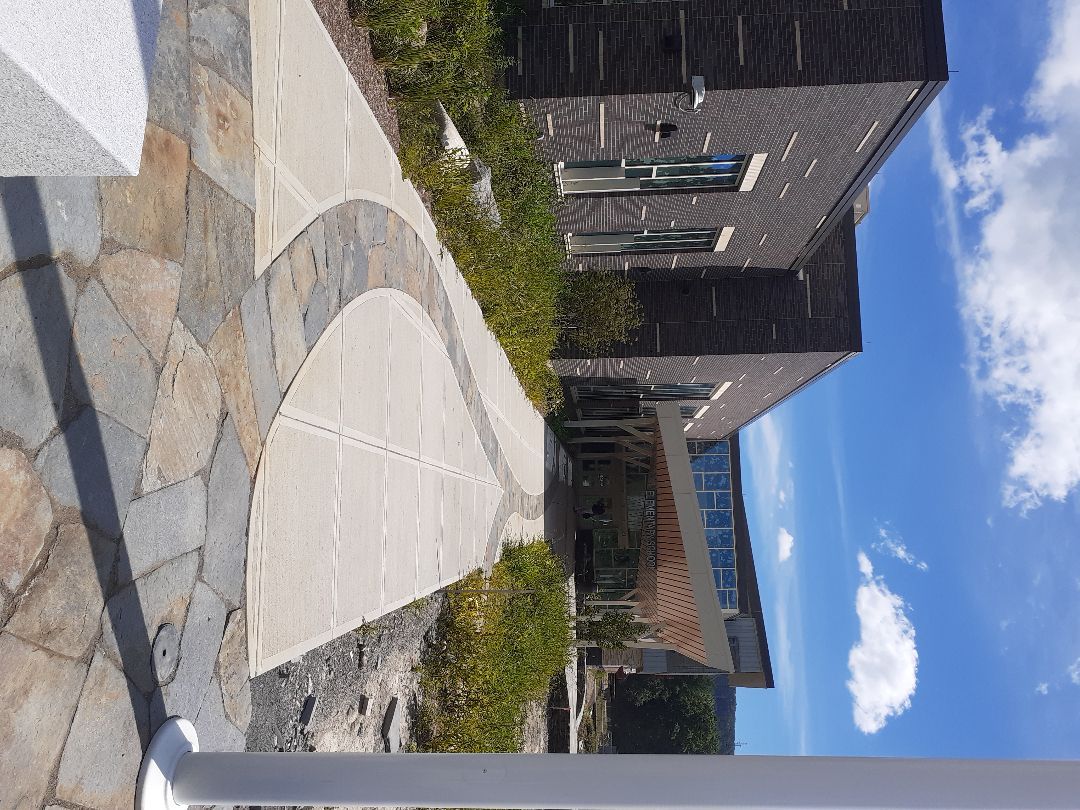 A brick building with a walkway in front of it