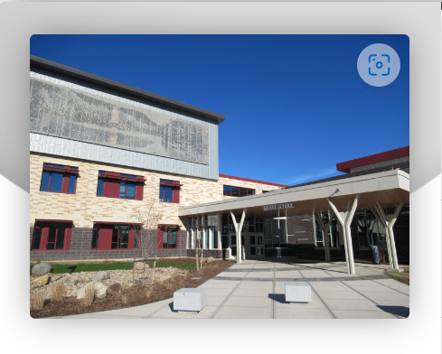 A large building with a blue sky in the background